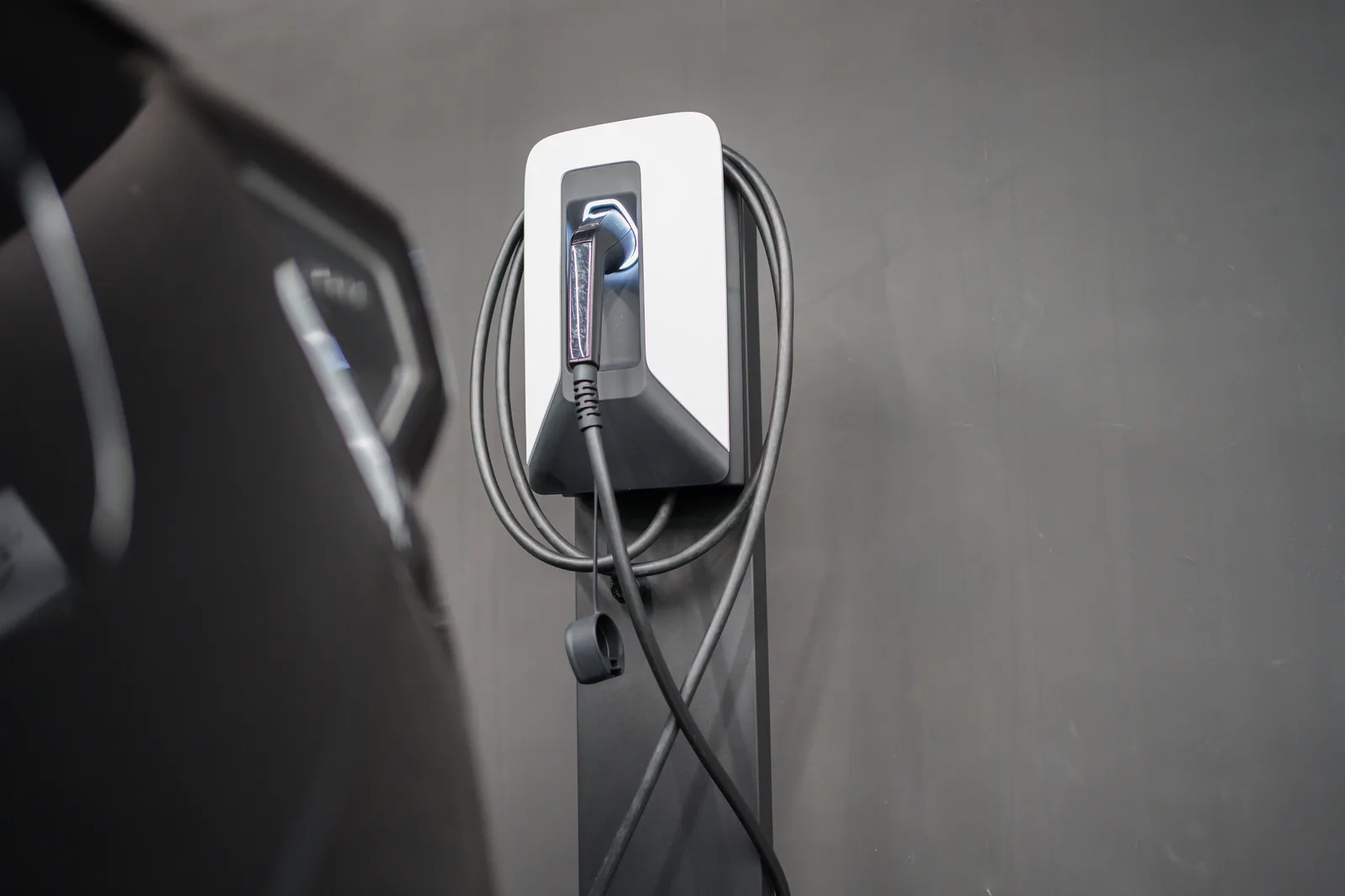 EV charger plugged in at a home garage